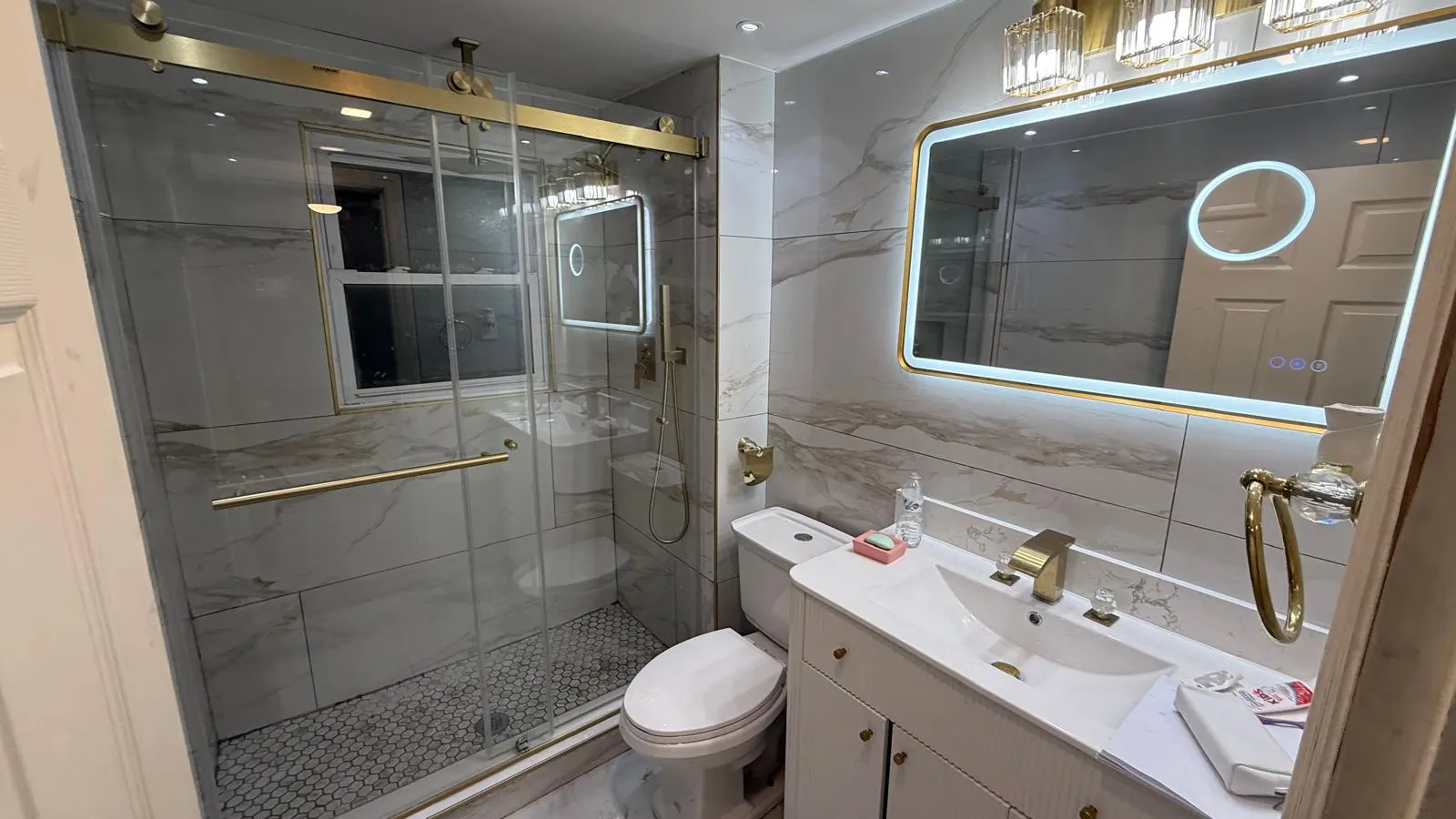 General contractor in Lynn, MA, a finished bathroom with tile shower and glass door