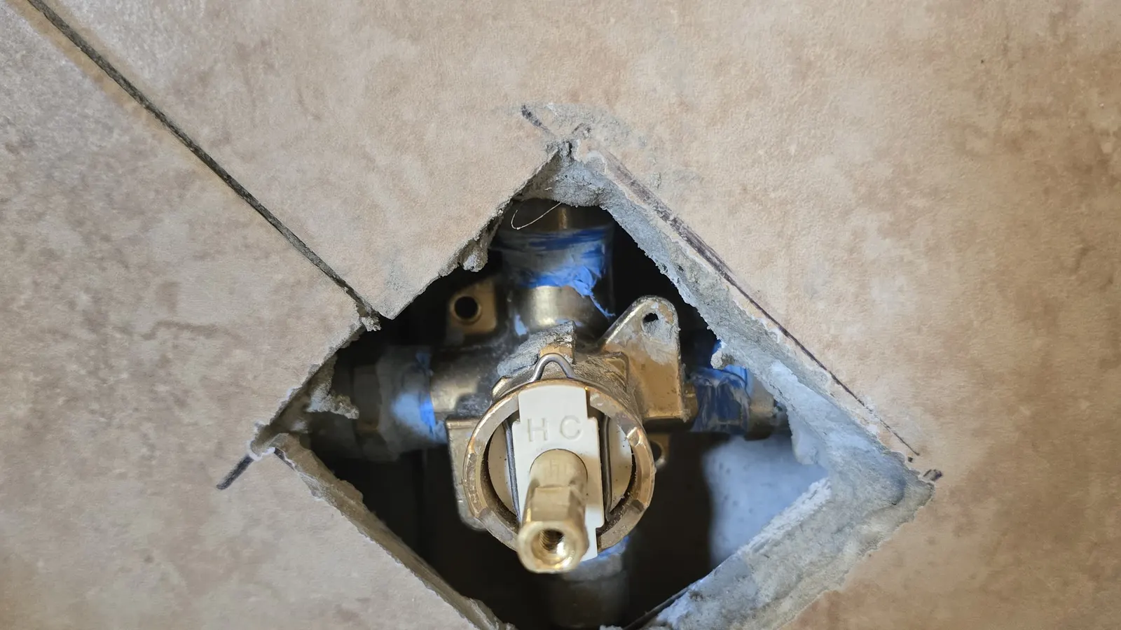 Leak repair in Lynn, MA with a shower valve exposed behind tile