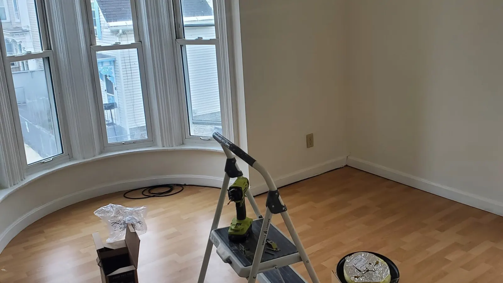 Painters in Lynn, MA, a freshly painted room with bay windows and a step ladder